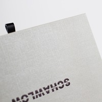 Boîte d'emballage haut de gamme en papier texturé avec logo estampé à chaud et poignée en soie pour portefeuille