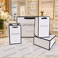 Sac en papier personnalisé avec logo pour vêtements, sac de shopping blanc de luxe avec poignée en ruban pour boutique, vente en gros