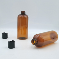 Bouteille en plastique PET ambrée en forme de balle de 16 oz, 12 oz, 8 oz avec bouchons à disque noir lisse pour l'emballage de shampoing, gel douche, lotion, huile