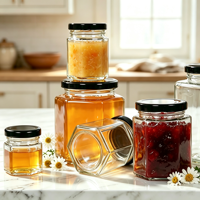 Vente en gros de pots en verre hexagonaux transparents vides pour le miel, la confiture, la sauce chili, la pâte de citron avec couvercle en métal