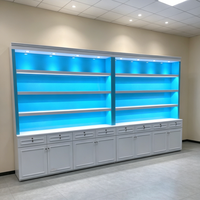 Étagère de présentation moderne avec rétroéclairage LED bleu, vitrine multi-niveaux avec base verrouillable pour produits de tabac/produits pharmaceutiques