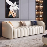 Ensemble de canapés en cuir véritable blanc crème moderne et confortable pour salon, avec décoration en métal doré et coussins
