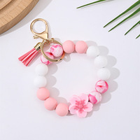 Cenda Fashion Silikon-Perlen-Armband Schlüsselanhänger mit Blumen-Charm Quaste Blumenmuster Perlen Elastisches Armband Schlüsselring für Frauen