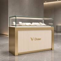 Vitrine d'îlot à bijoux en or brossé avec tiroirs de rangement, comptoir de présentation de bijoux en verre trempé à LED pour boutique de luxe