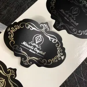 Etiquetas de embalaje con logotipo de oro rosa estampado de lámina de vinilo negro de gama alta personalizadas