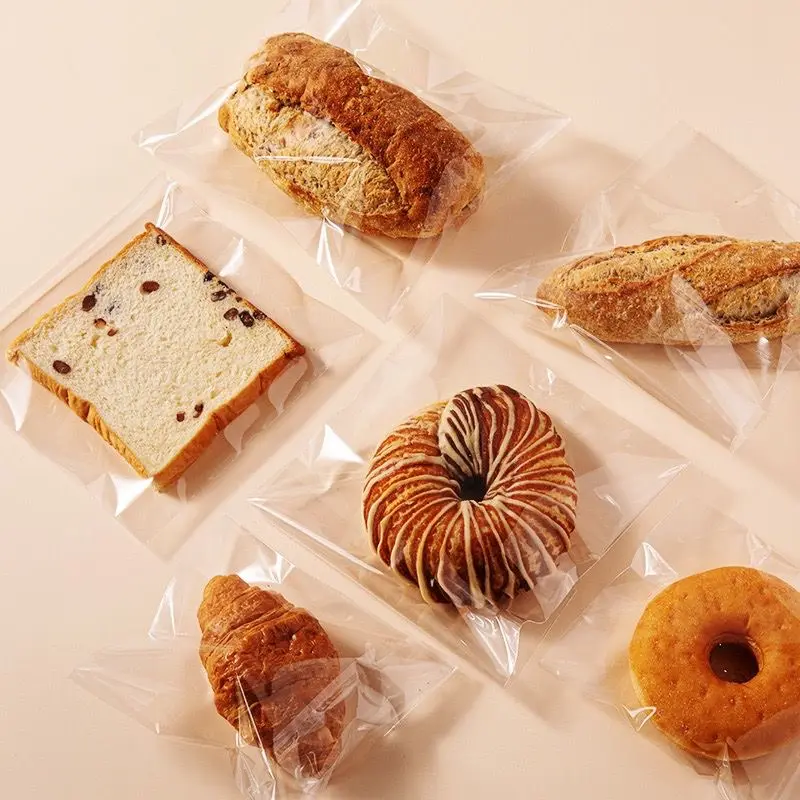 Commercio all'ingrosso trasparente per abbigliamento caramelle biscotti biscotti pane imballaggio alimentare Opp sacchetto di plastica con autoadesivo