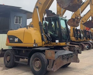 Excavatrice sur pneus CAT M317D2 <span class=keywords><strong>d</strong></span>'occasion à faible nombre <span class=keywords><strong>d</strong></span>'heures de fonctionnement avec dozer frontal, stabilisateurs arrière et ligne de brise-roche préinstallée pour l'asphalte - Product Image 3