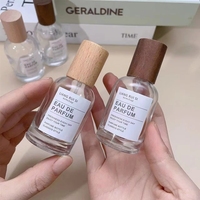 Flacon de parfum cylindrique de luxe à prix d'usine, base lourde, Dubaï, 30 ml, vide, avec pompe pulvérisatrice et sérigraphie sur bois