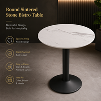 Table de bistrot ronde en pierre frittée avec base métallique stable, design minimaliste pour cafés, hôtels et restaurants