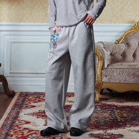 Pantalon de survêtement unisexe en molleton bouclette coupe large et oversize, avec logos imprimés numériquement effet craquelé, style décontracté vintage