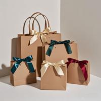 Vente en gros sacs-cadeaux en papier kraft blanc avec feuille d'or gaufré laminé personnalisable pour bijoux vêtements emballage de lunettes