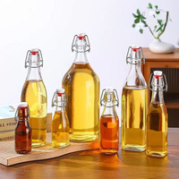 Bouteille en verre transparent Offre Spéciale 8oz 16oz 32oz avec couvercle hermétique à couvercle rabattable pour boissons gazeuses Kombucha