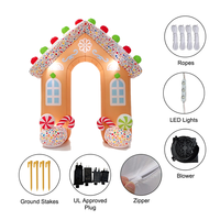Arche gonflable en forme de maison de pain d'épices de Noël avec des bâtons de sucre et des sucettes pour la décoration d'entrée d'événements festifs