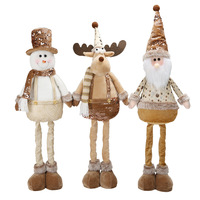 Beige Glitzer-Pailletten Ausziehbare Beine Weihnachtspuppen-Trio Schneemann Elch Weihnachtsmann für Boutique-Feiertagsdekoration