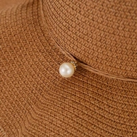 Vente en gros de chapeau de paille sombrero pour femme élégante tendance printemps été pêche spray perle nœud large bord chapeau de protection solaire jonc herbe
