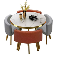 Ensemble de table à manger ronde moderne, luxueuse, durable, imperméable et écologique avec chaises en métal pour une utilisation en extérieur dans les hôtels, 1 table et 4 chaises