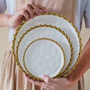 Venda quente casa restaurante criativo forma redonda borda dourada pratos de cerâmica para festa de casamento pratos de jantar de porcelana com bordas frisadas