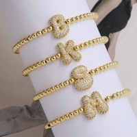 Bracelet unisexe en acier inoxydable plaqué or avec chaîne à billes, motif double face coquillage et fleur trèfle à quatre feuilles, idéal pour un cadeau