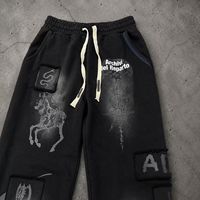 Pantalon large à cordon de serrage Kornit DTG, motif graphique vintage à lettrage ondulé et éclaboussures d'éclairs, entièrement imprimé, avec trous effilochés, coupe ample