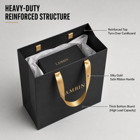 Sac shopping en papier noir de luxe personnalisé 300 g/m² avec logo estampé à chaud or et poignée en ruban satiné pour boutique