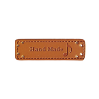 Étiquettes de taille imprimées d'étiquettes de vêtements en cuir durables en relief OEM/ODM avec techniques brodées