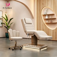 Table de massage moderne en cuir pour salon de beauté, base cylindrique en bois, lit électrique en velours pour soins du visage et extensions de cils