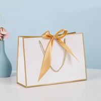 Sacs cadeaux en papier de luxe personnalisés avec poignée en ruban et impression de logo pour l'emballage de détail