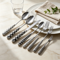Ensemble de couverts en acier inoxydable à motif blanc et noir, avec poignées en céramique, pour une table de cuisine lumineuse et coordonnée