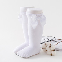 Vente en gros Chaussettes longueur genou pour petites filles Couleur pure Automne Printemps Étudiants Enfants Robe en coton Chaussettes tubulaires Collants