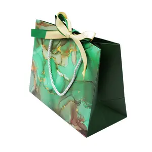 Özel Logo marka baskılı kağıt paketleme çantası lüks hediye takı butik yay süs naylon kolu ile kağıt çanta