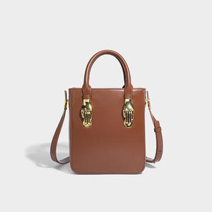 Brown leather handbag with gold palm <b>buckle</b>, fashionable and personalized women's <b>bag</b> - Product Image 1