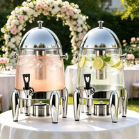 Distributeur de jus en acier inoxydable FLEY avec couvercle en dôme, robinet et support surélevé pour service de restauration de boissons en buffet d'hôtel
