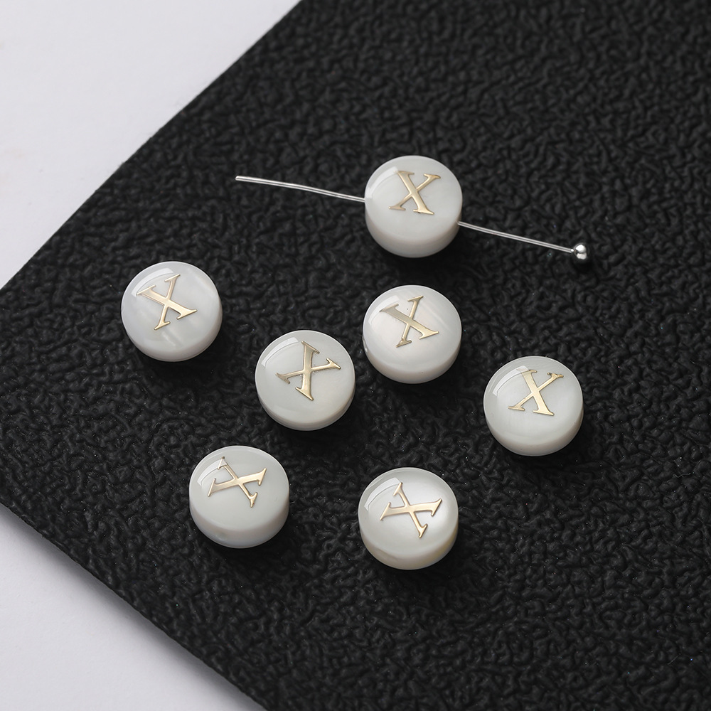 Perles lettres coquillage -- X