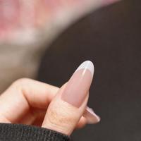 Faux ongles à presser de taille moyenne, base rose nude, pointe française blanche et motif ligne ondulée, finition brillante