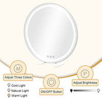 Miroir de maquillage rond blanc avec anneau lumineux à lumière chaude et base à pieds discrets, miroir de vanité LED de table