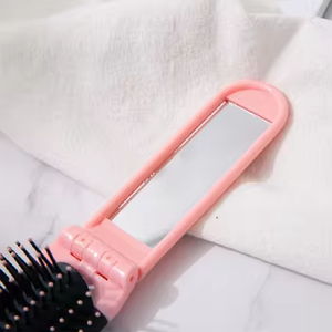 Marque privée vente en gros de mini brosse à cheveux portable en plastique pliante démêlante avec miroir pour le voyage - Product Image 5