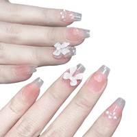 Vente en gros usine : Faux ongles à presser courts, uniques, couleur blush avec nœud, faible MOQ, motifs variés et styles personnalisés pris en charge