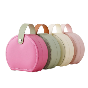 Boîte à bijoux ronde de petite taille en cuir PU avec poignée, doublure en velours, fermeture à bouton, étui de rangement portable pour bijoux de voyage, vente en gros d'usine - Product Image 1