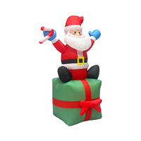 Père Noël gonflable de 6 pieds assis sur une boîte cadeau avec une canne en sucre pour la décoration de jardin, de cour ou de fête en extérieur