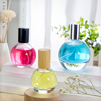 A-Best Flacon de parfum rond en verre haut de gamme avec pulvérisateur et impression sérigraphique disponible en tailles 30ml/50ml/100ml