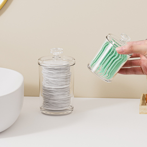 A minimalist HAY Floss Pick Dispenser, partially filled with white floss picks.