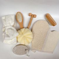 L'ensemble de bain promotionnel comprend un gant éponge de bain, un épurateur d'ongles et de pieds, une brosse à cheveux en bois, un bandeau, un rouleau pour le visage avec sac en lin