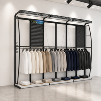 Système d'affichage mural pour vêtements en métal noir à dessus incurvé, avec boîte lumineuse LED, logo et panneau perforé sur mesure