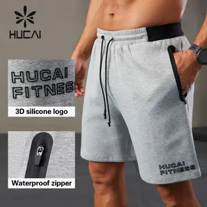 HUCAI logotipo personalizado polar poliéster silicona logotipo impresión cremallera bolsillo entrenamiento gimnasio deportes aire algodón Jogger pantalones cortos de chándal para hombres