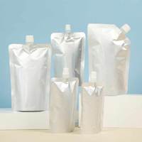 Vente en gros de sacs d'emballage de liquide transparents 250ml 500ml 1000ml Pochette à bec verseur pour jus de thé PET/PE Pochette debout pour l'eau et les aliments liquides