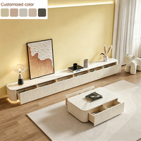 Meuble TV flottant minimaliste crème 2026 avec table basse, armoire texturée côtelée, éclairage LED et tiroir de rangement pour salon