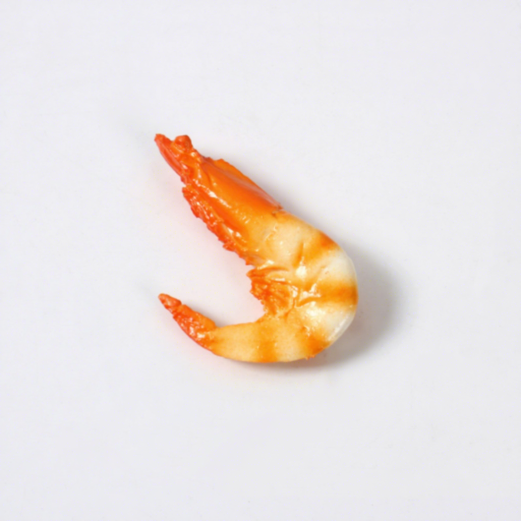 Petits aimants de réfrigérateur en forme de crevettes jaunes.