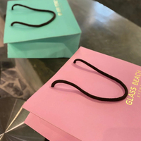 Sac à provisions de cadeau d'emballage de vêtement en papier coloré de luxe imprimé de logo personnalisé avec poignée en ruban