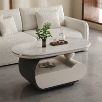 Table basse mobile incurvée en crème, surface en pierre microcristalline, base de rangement avec roulettes silencieuses, bureau minimaliste pour salon