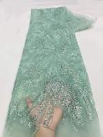 Tissu de dentelle de luxe brodé de perles et de sequins à motifs floraux pour vêtements de mariée